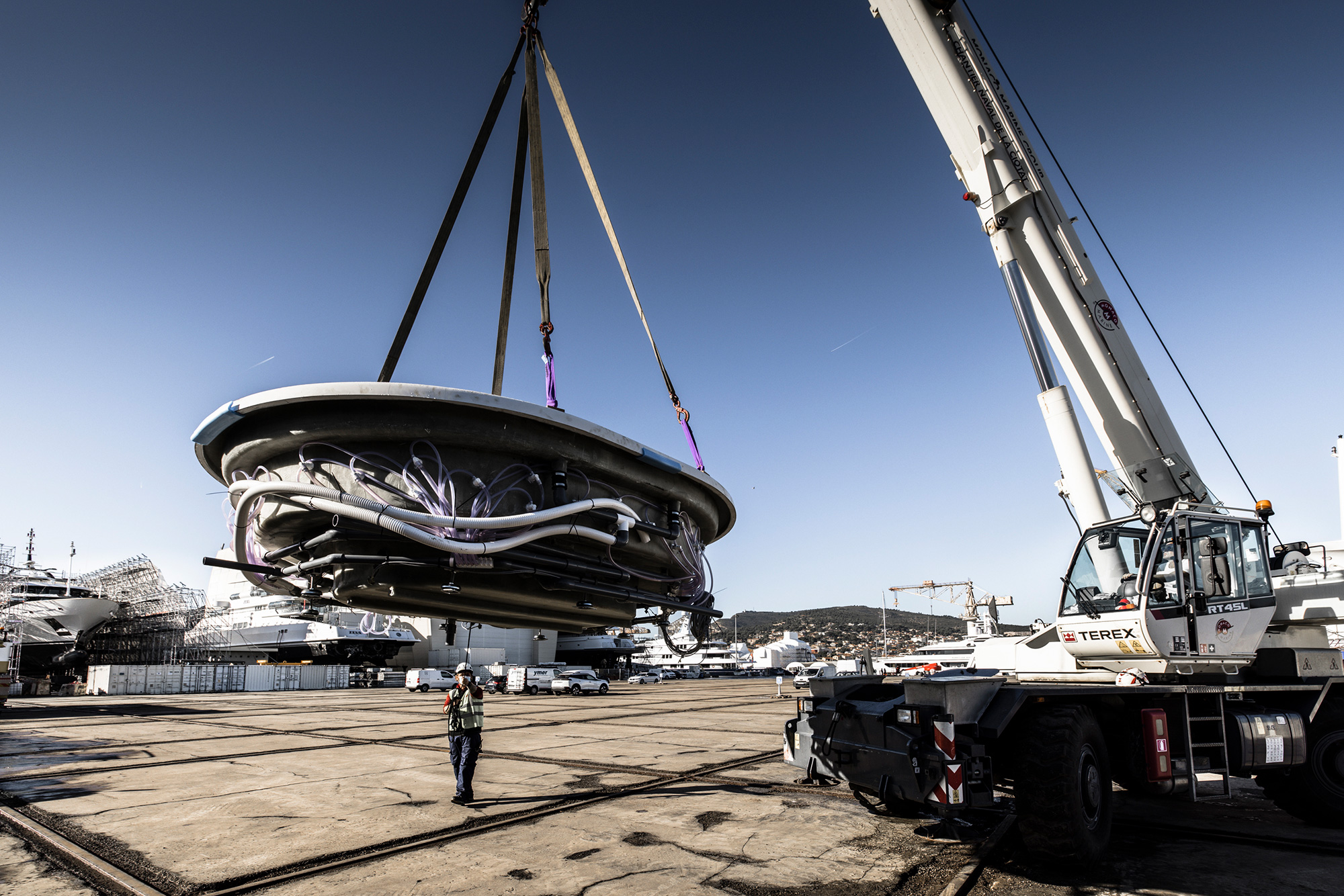 Riverian composite spa vessel being lifted into a superyacht refit yard